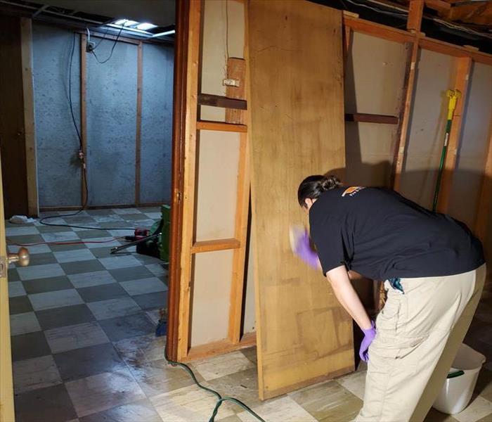 SERVPRO employee restoring wood after water damage